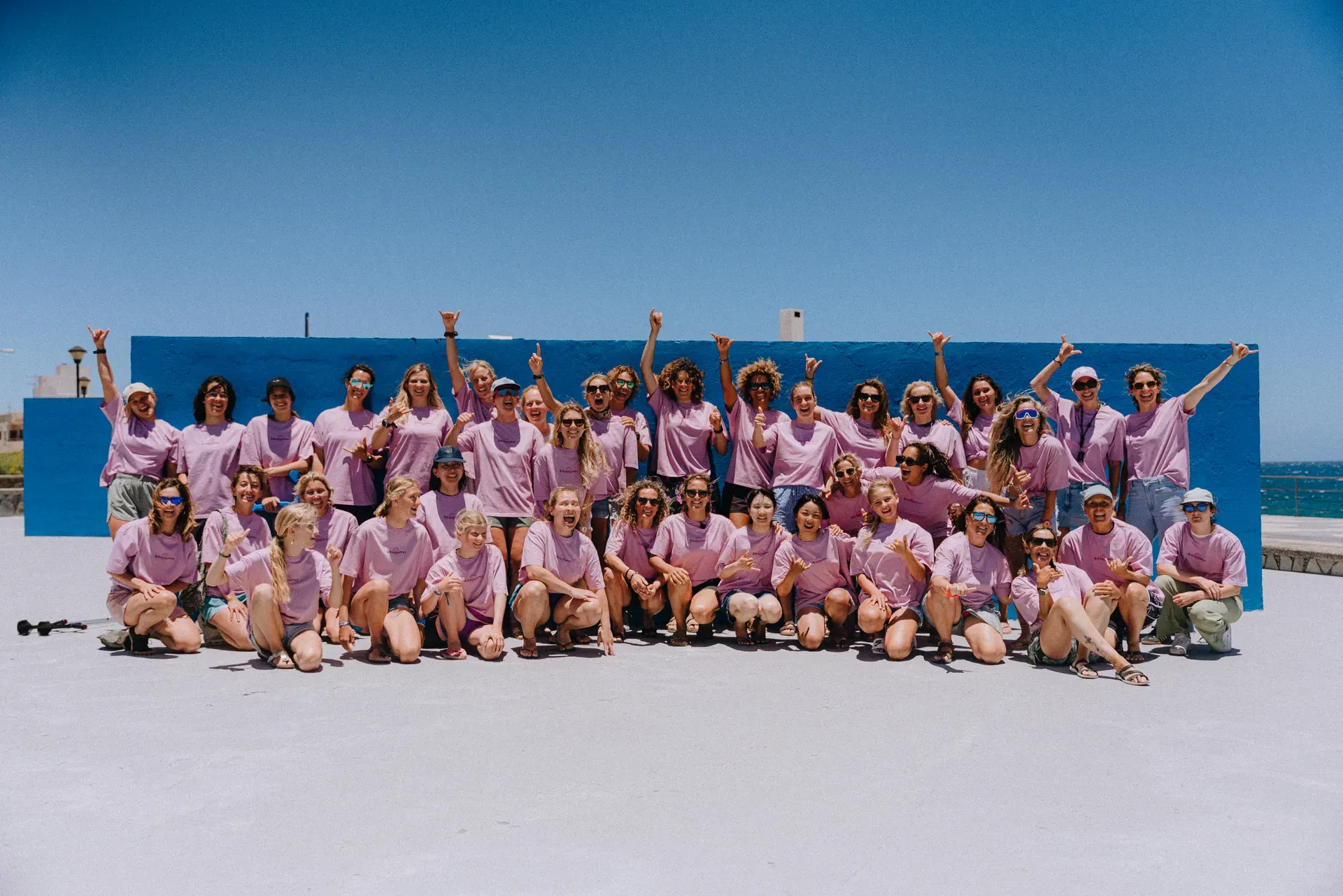 Girls on Tour community gathered by the ocean